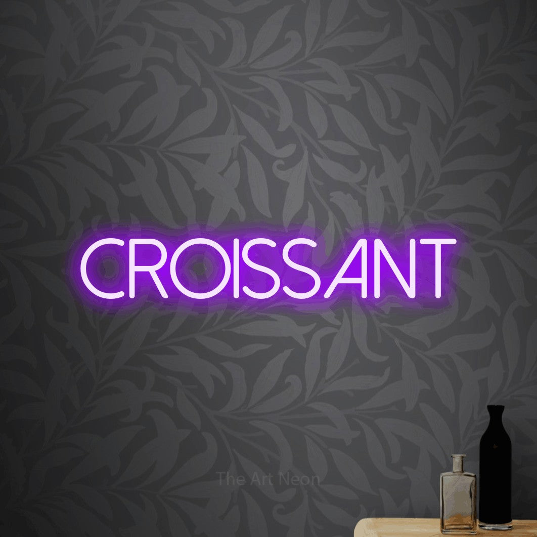 LED neon sign reading “croissant”, arranged in a single line.