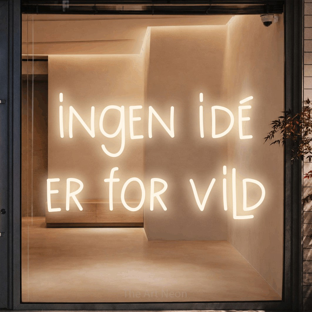 LED neon sign reading “ingen idé er for vild”, arranged in 2 lines.