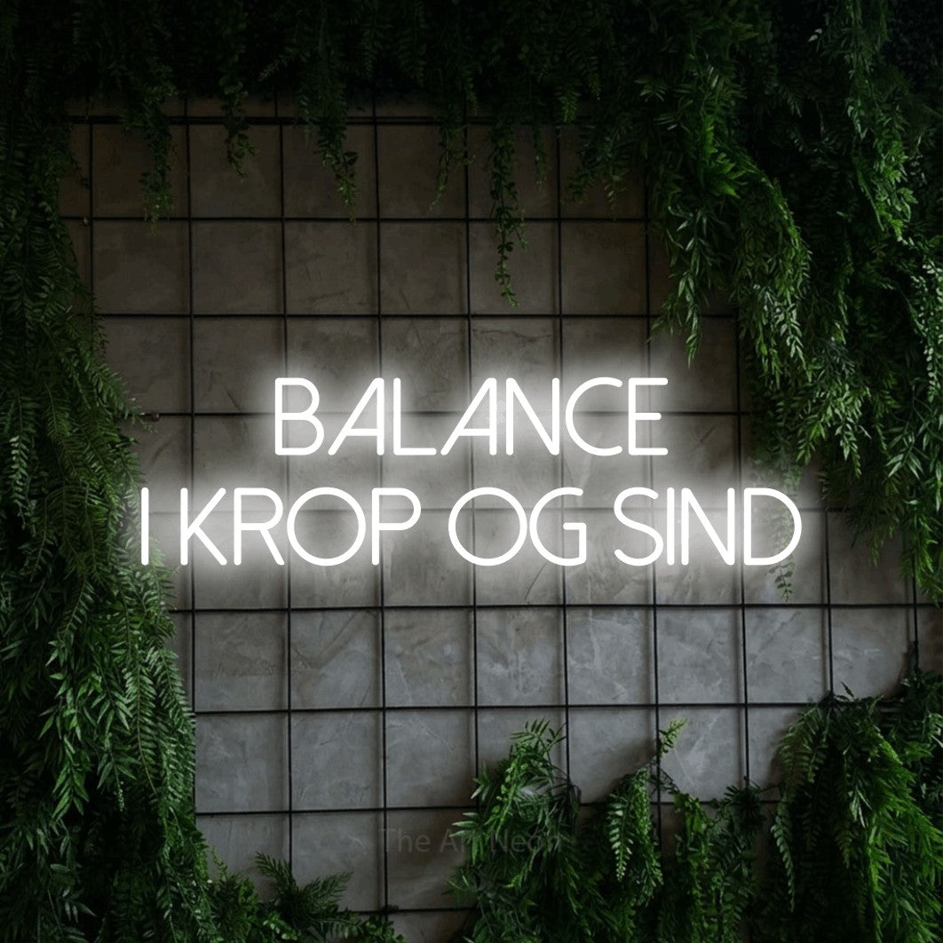 LED neon sign reading “balance i krop og sind”, arranged in 2 lines.