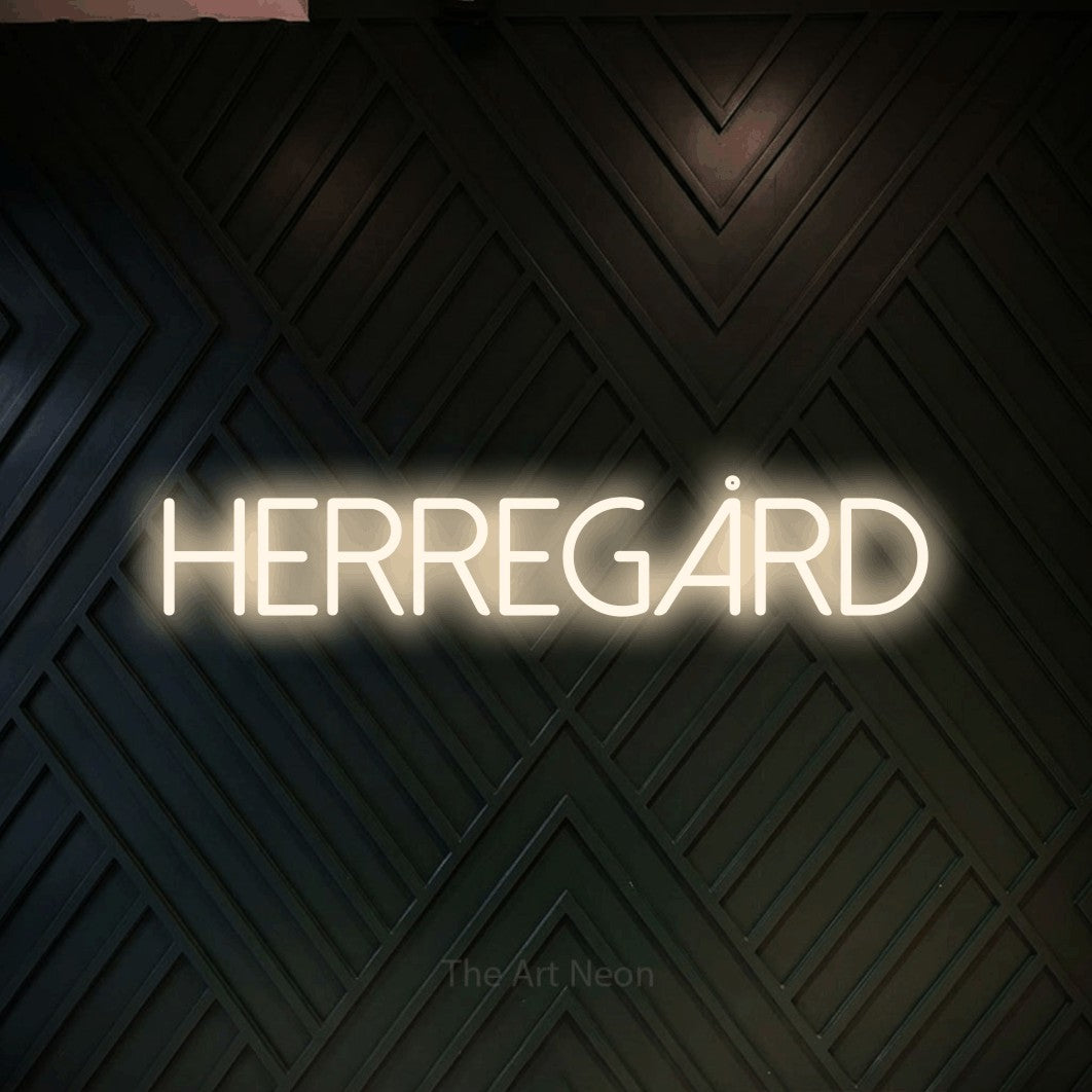 LED neon sign reading “Herregård”, arranged in a single line.