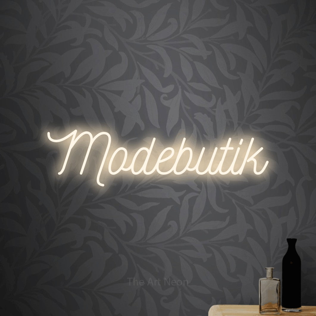 LED neon sign reading “Modebutik”, arranged in a single line.