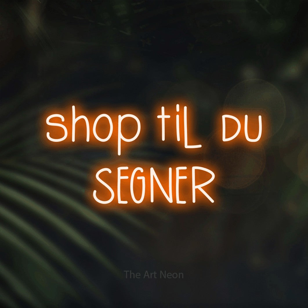 LED neon sign reading “shop til du SEGNER”, arranged in 2 lines.