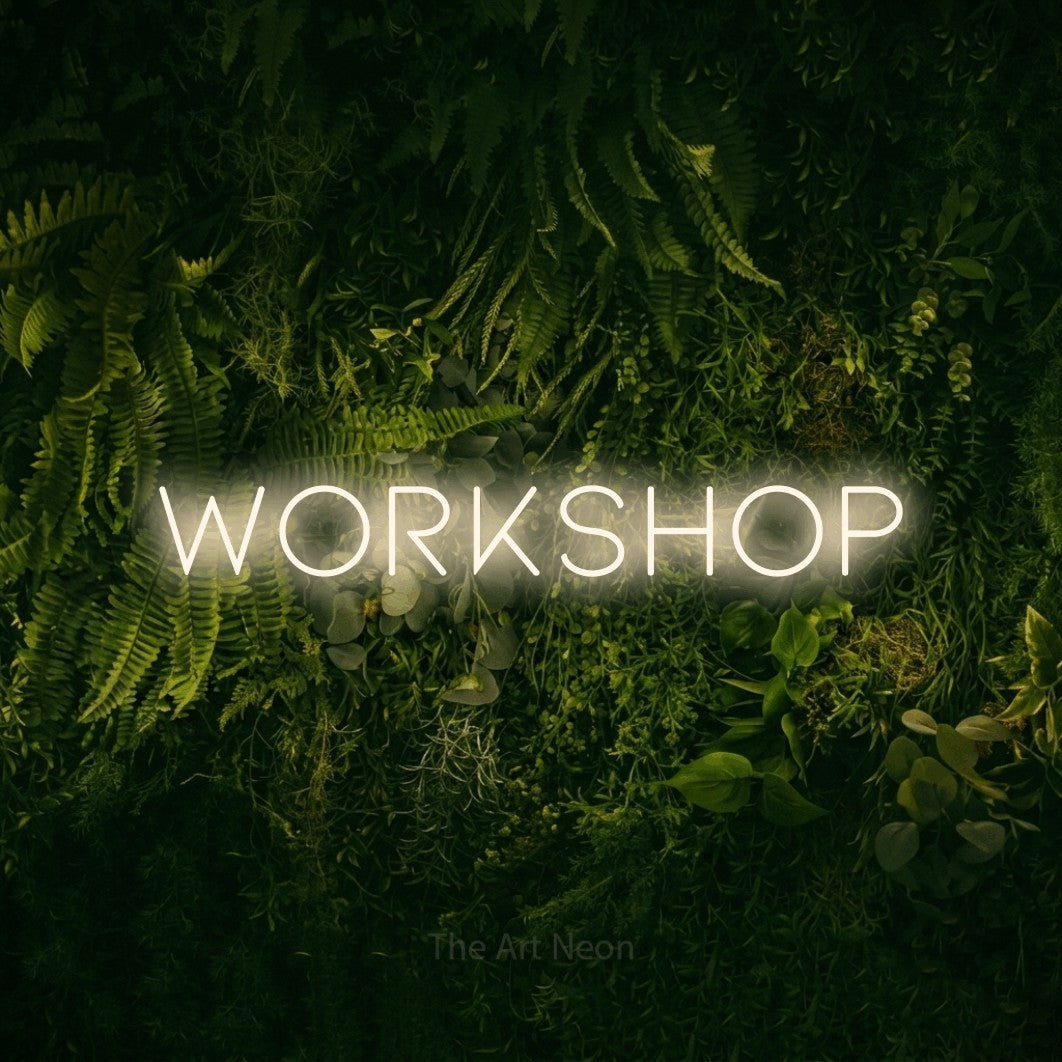 LED neon sign reading “WORKSHOP”, arranged in a single line.