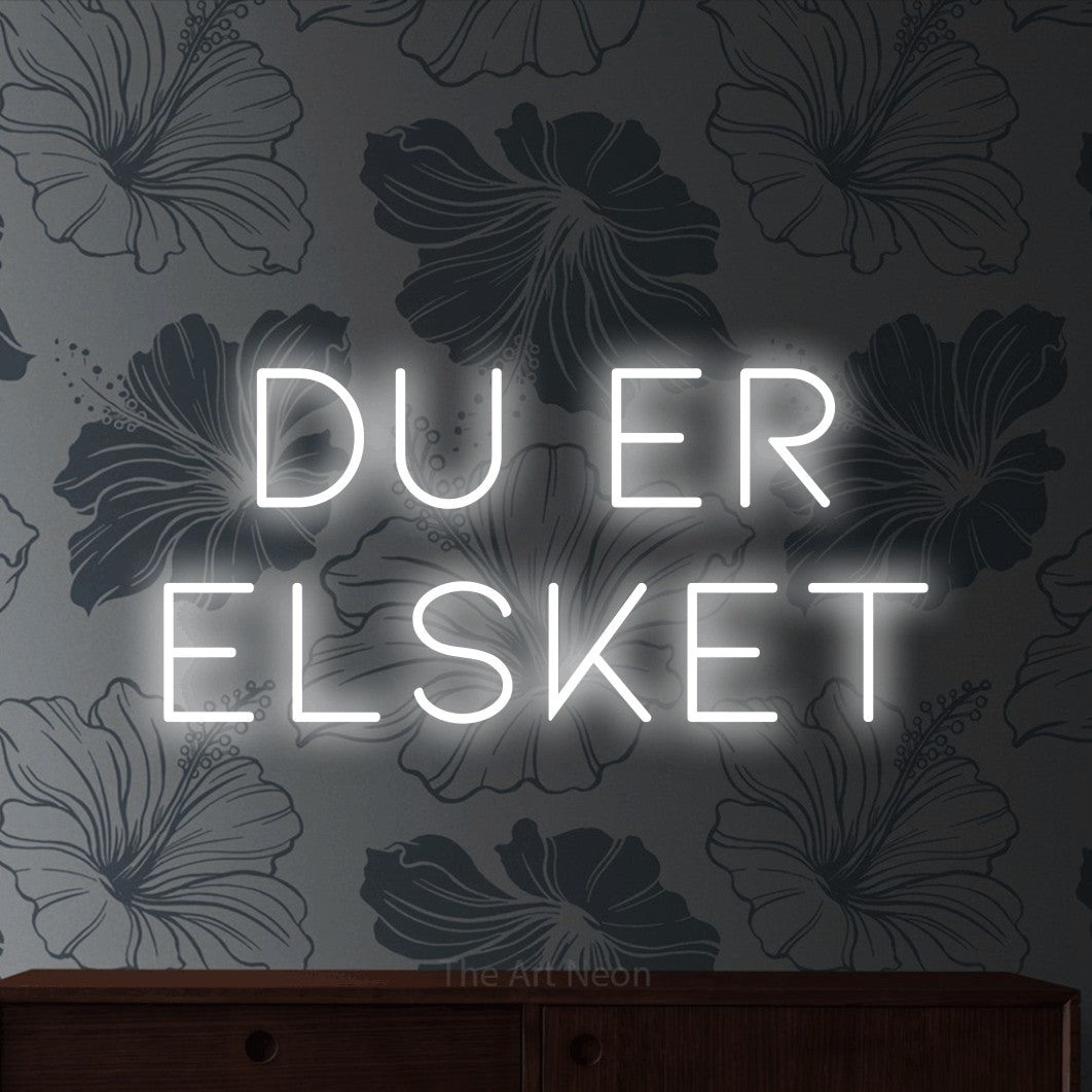 LED neon sign reading “DU ER ELSKET”, arranged in 2 lines.