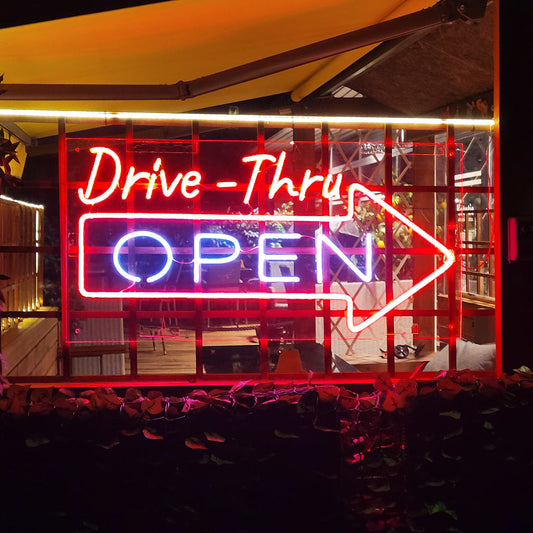 "Drive Thru Open Neonkyltti" shines brightly, inviting customers to enjoy the convenience of drive-thru service.