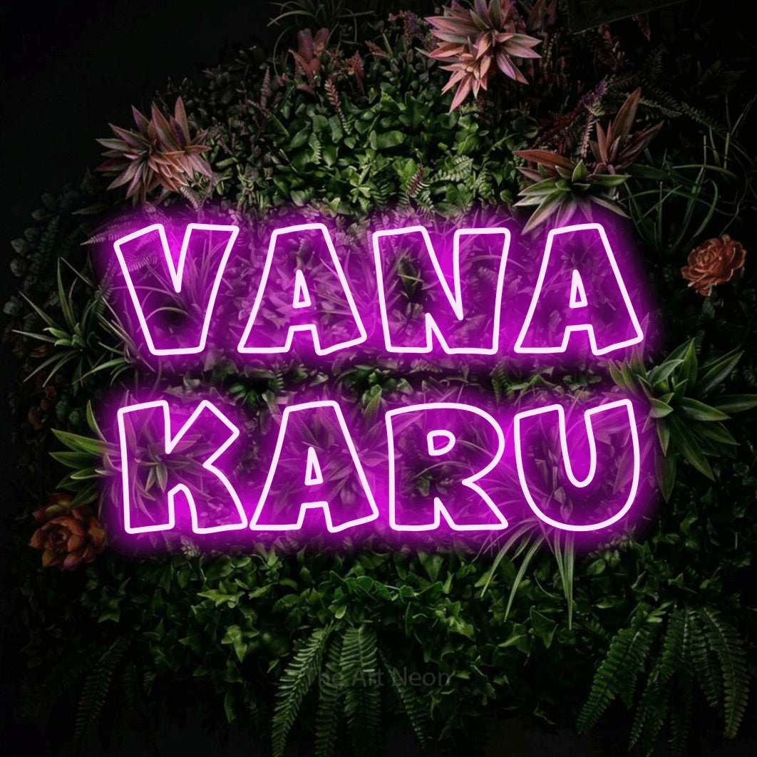 LED neon sign reading “Vana Karu”, arranged in 2 lines.