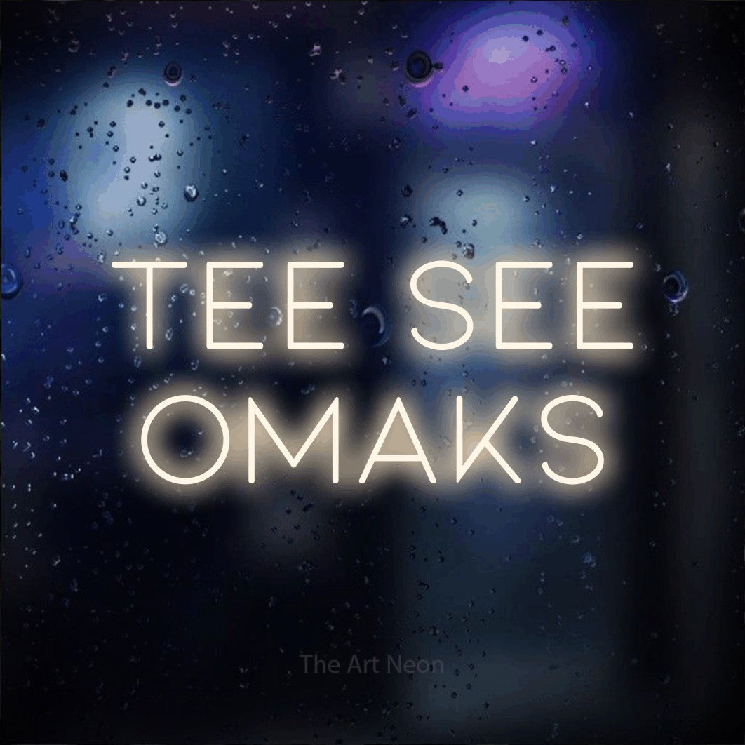 LED neon sign reading “tee see omaks”, arranged in 2 lines.