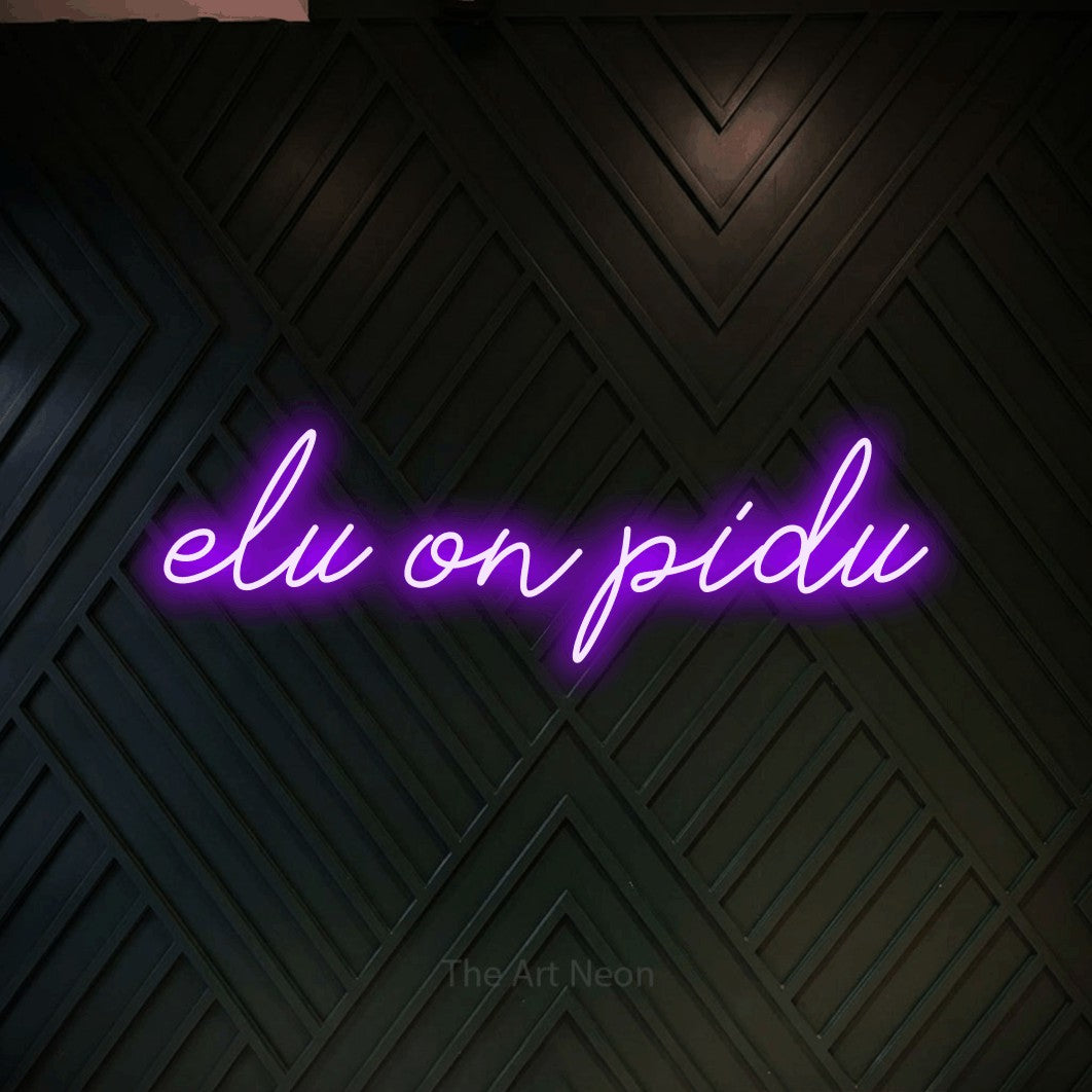 LED neon sign reading “elu on pidu”, arranged in a single line.