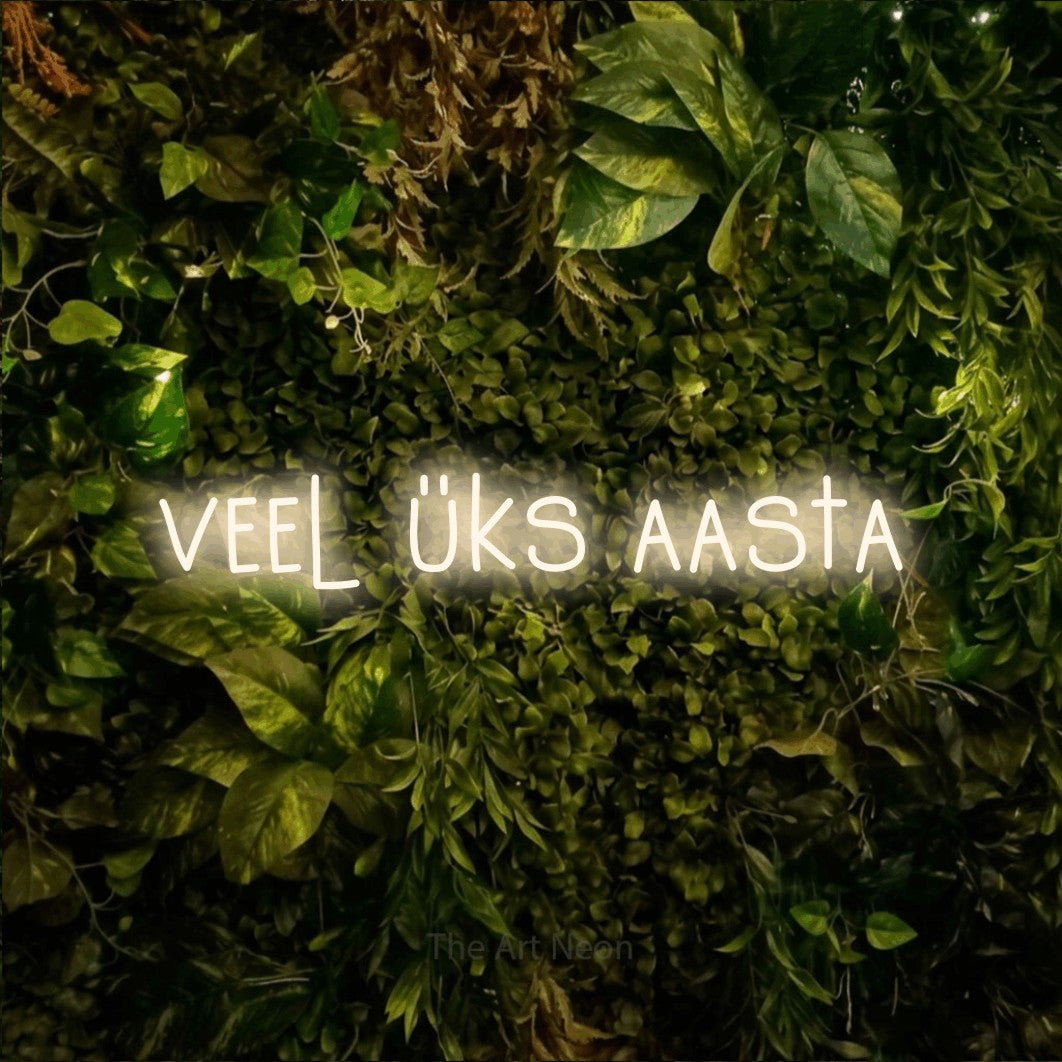 LED neon sign reading “veel üks aasta”, arranged in a single line.