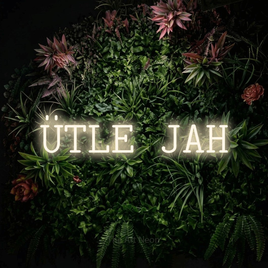 LED neon sign reading “ÜTLE JAH”, arranged in a single line.