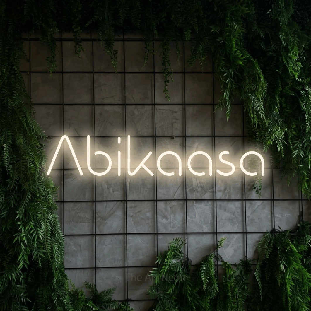 LED neon sign reading “Abikaasa”, arranged in a single line.