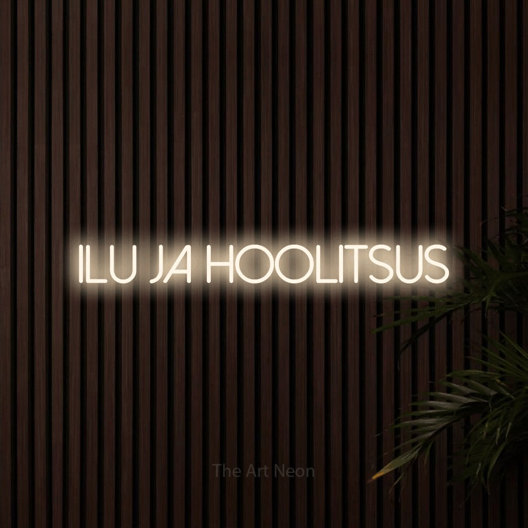 LED neon sign reading “Ilu Ja Hoolitsus”, arranged in a single line.