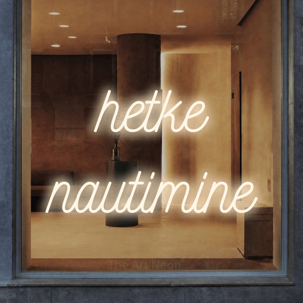LED neon sign reading “hetke nautimine”, arranged in 2 lines.