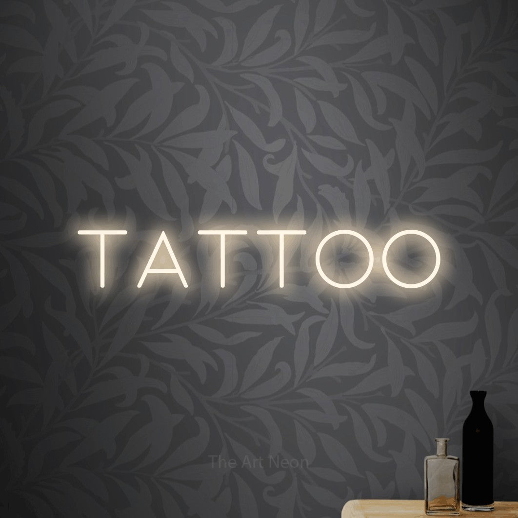 LED neon sign reading “tattoo”, arranged in a single line.