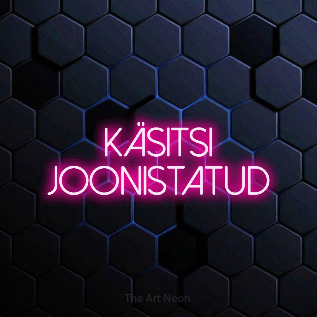 LED neon sign reading “KÄSITSI JOONISTATUD”, arranged in two lines.