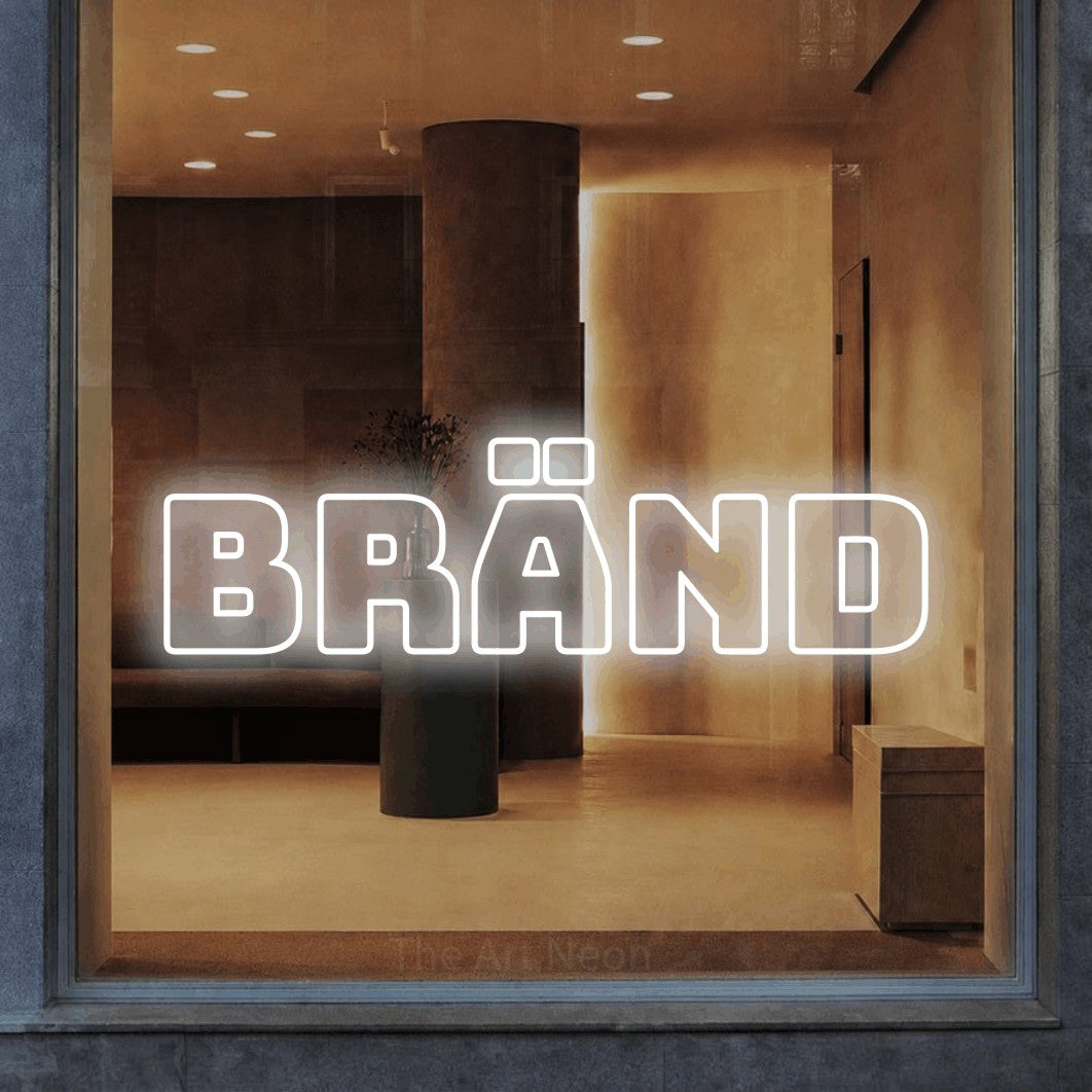 LED neon sign reading “BRÄND”, arranged in a single line.
