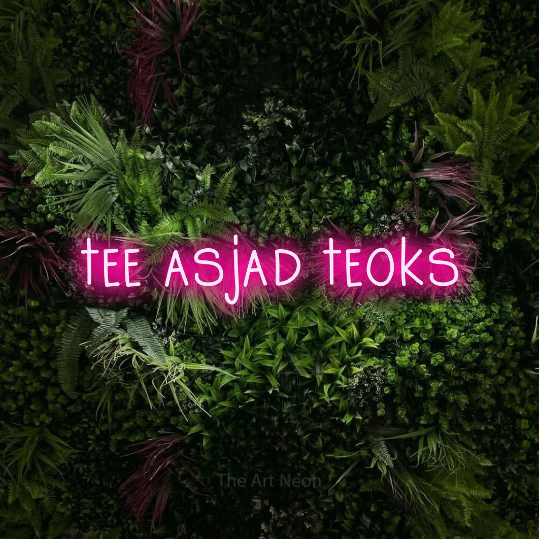 LED neon sign reading “tee asjad teoks”, arranged in a single line.