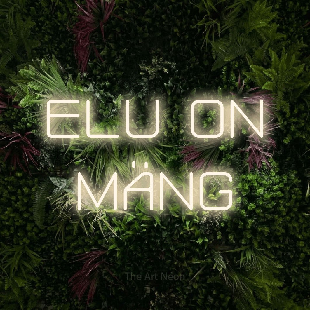 LED neon sign reading “ELU ON MÄNG”, arranged in two lines.