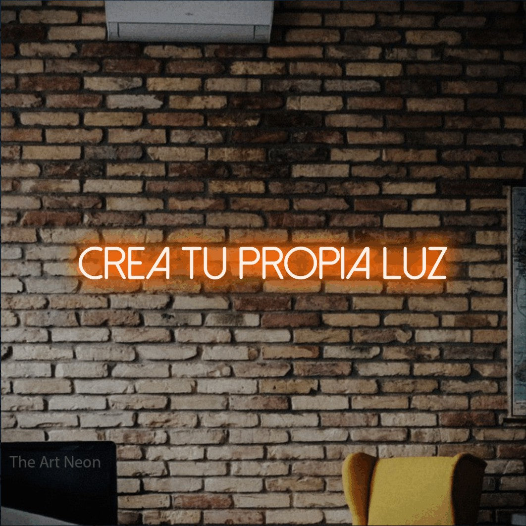 LED neon sign reading “CREA TU PROPIA LUZ”, arranged in a single line.