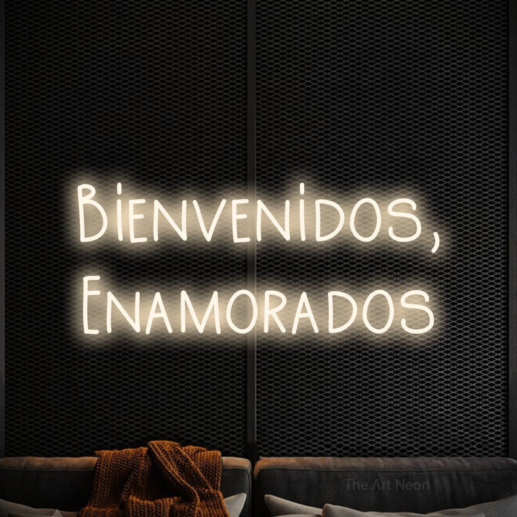 LED neon sign reading “Bienvenidos, Enamorados”, arranged in 2 lines.