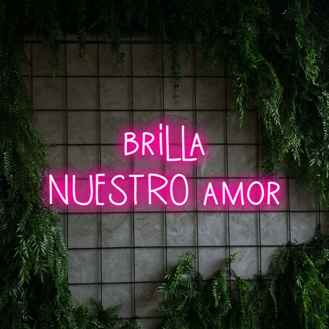 LED neon sign reading “brilla NUESTRO amor”, arranged in 2 lines.