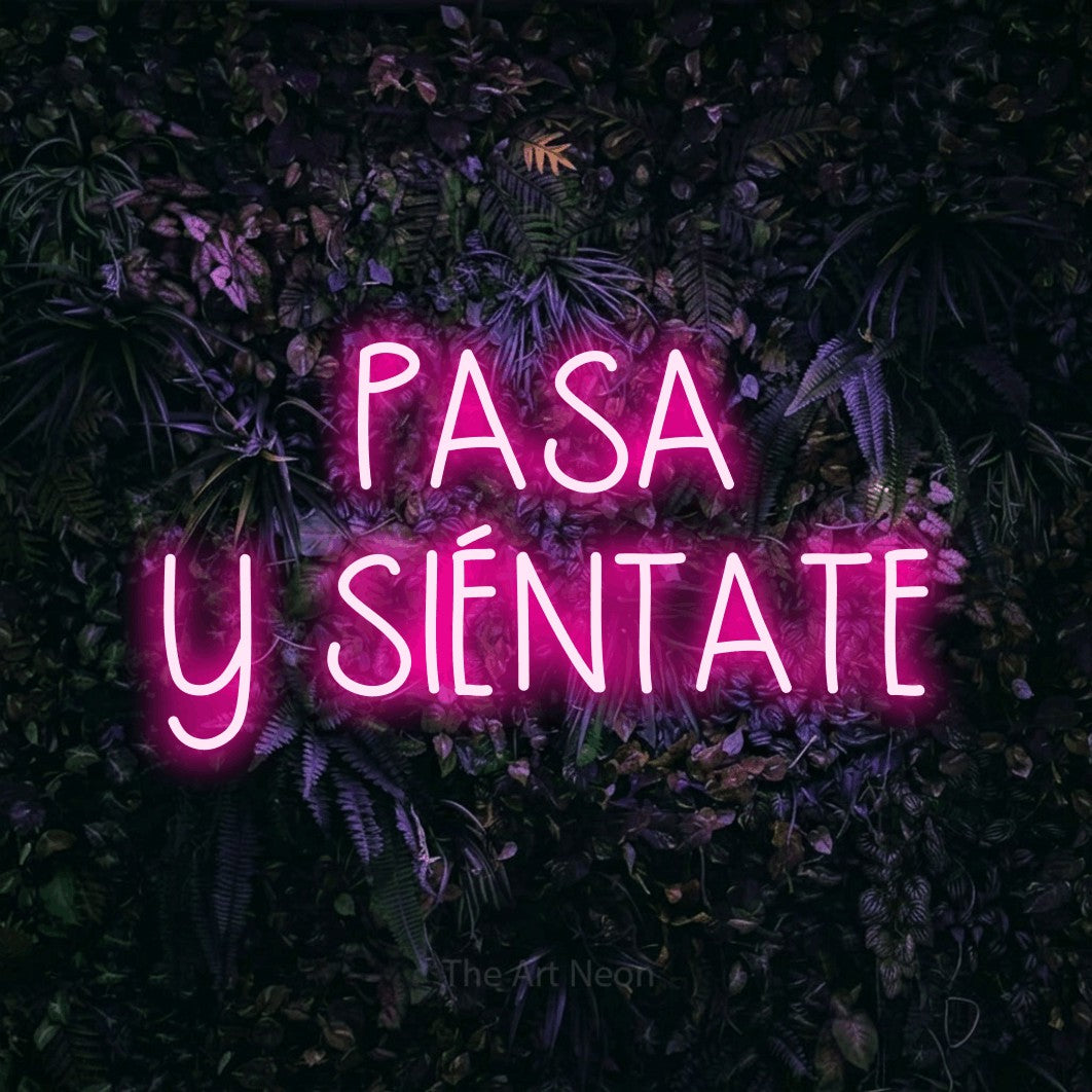 LED neon sign reading “PASA Y SIÉNTATE”, arranged in 2 lines.