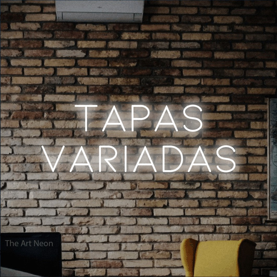 LED neon sign reading “TAPAS VARIADAS”, arranged in 2 lines.