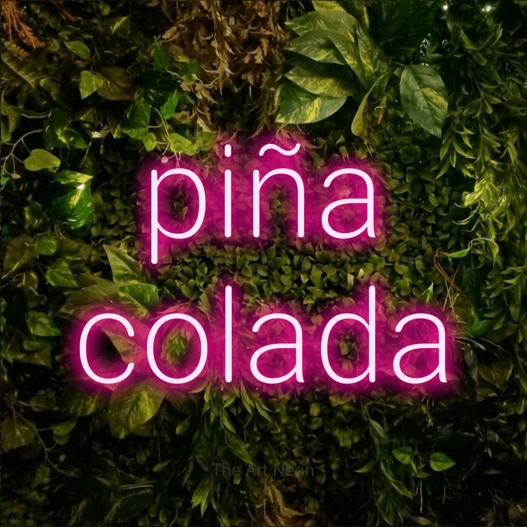 LED neon sign reading “piña colada”, arranged in 2 lines.