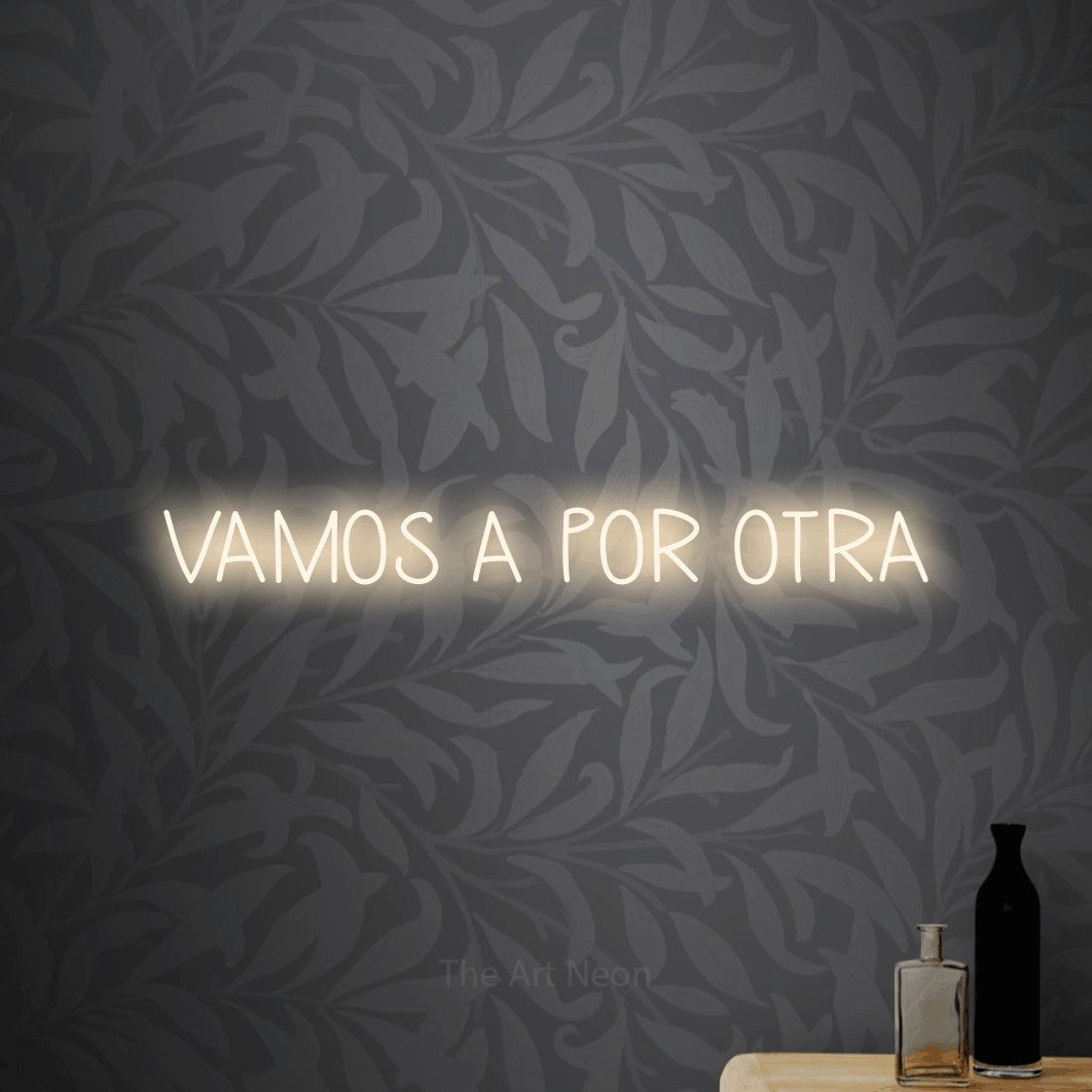 LED neon sign reading “VAMOS A POR OTRA”, arranged in a single line.