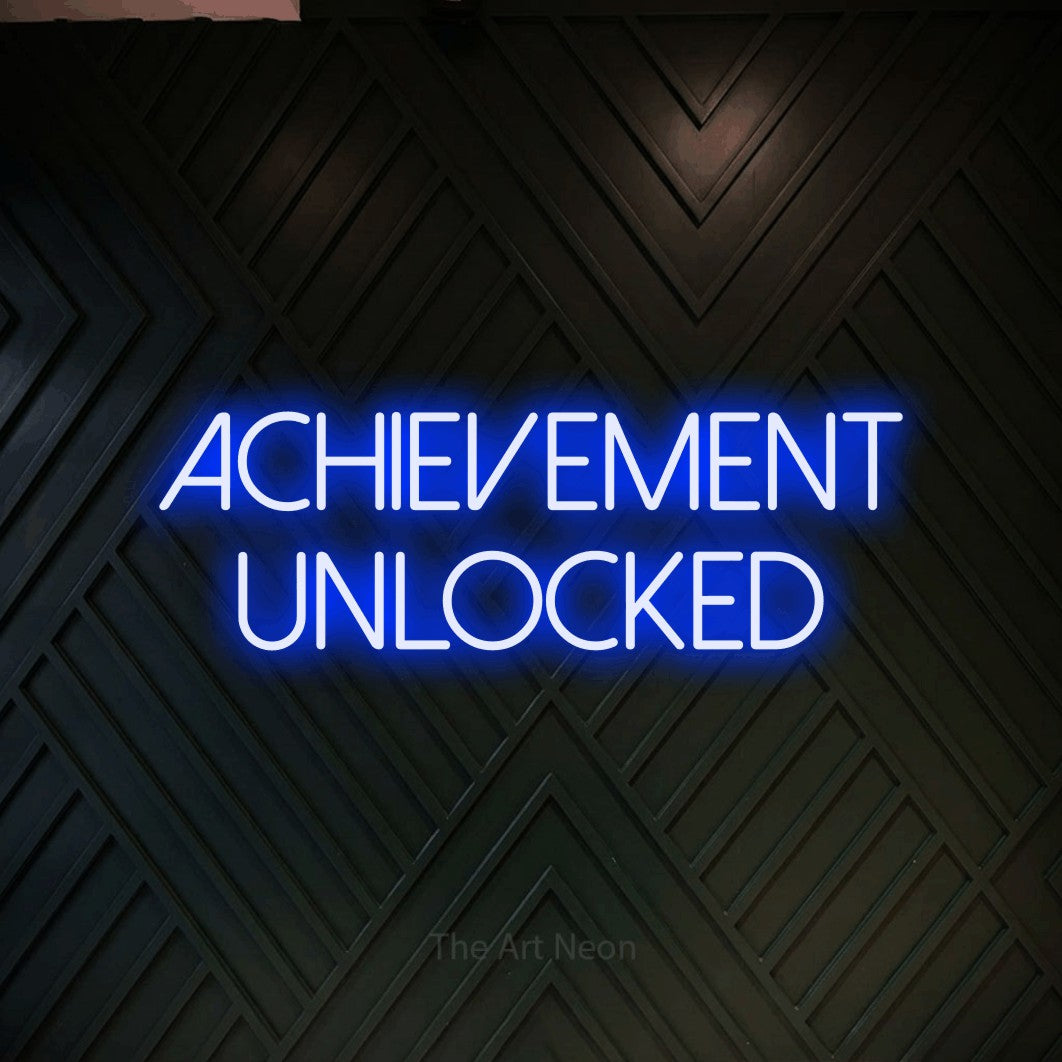 LED neon sign reading “ACHIEVEMENT UNLOCKED”, arranged in 2 lines.