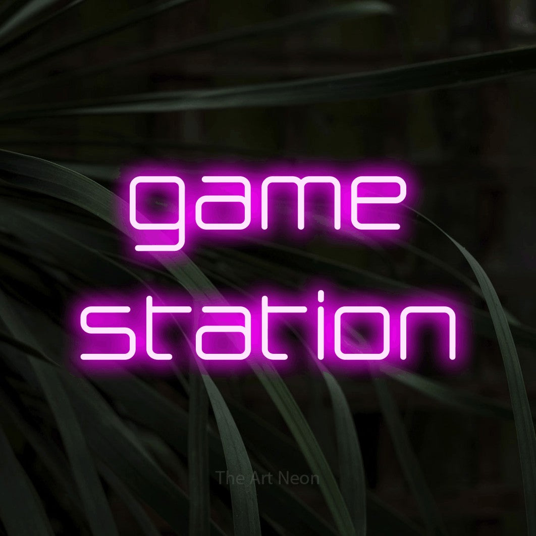 LED neon sign reading “game station”, arranged in 2 lines.