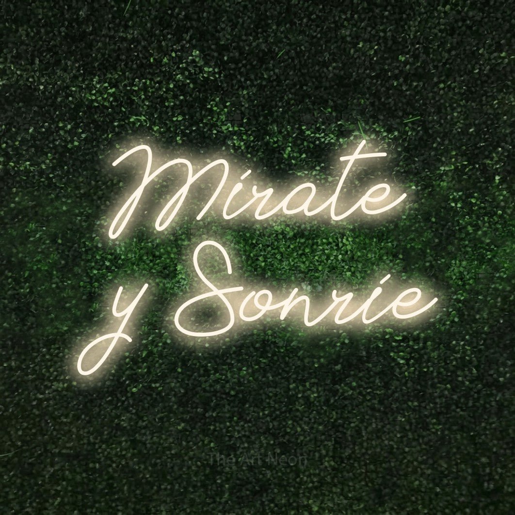 LED neon sign reading “Mírate y Sonríe”, arranged in 2 lines.