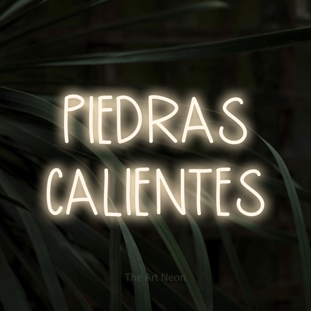 LED neon sign reading “PIEDRAS CALIENTES”, arranged in 2 lines.