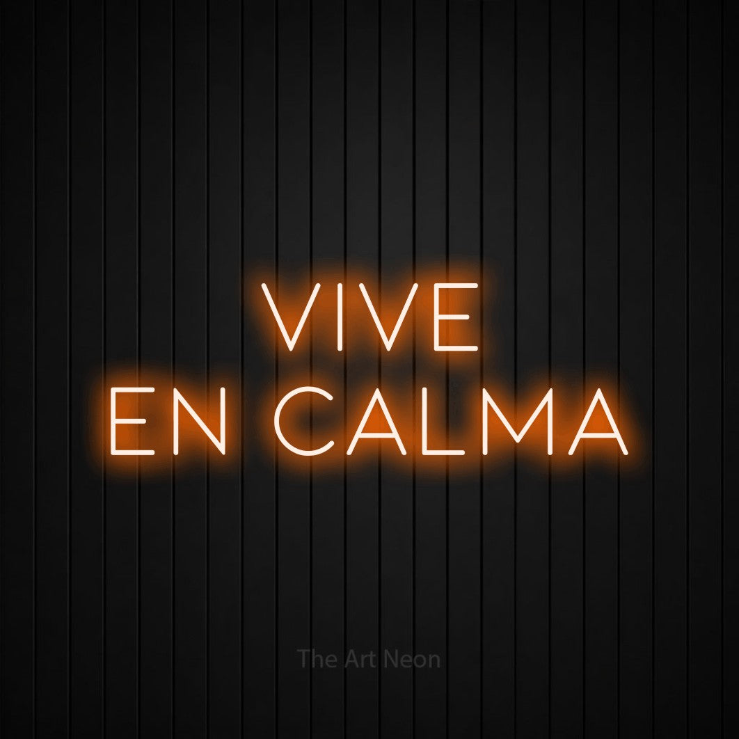 LED neon sign reading “vive en calma”, arranged in 2 lines.