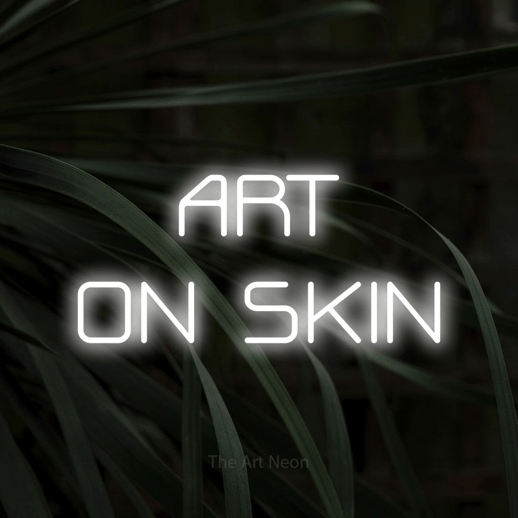 LED neon sign reading “ART ON SKIN”, arranged in 2 lines.