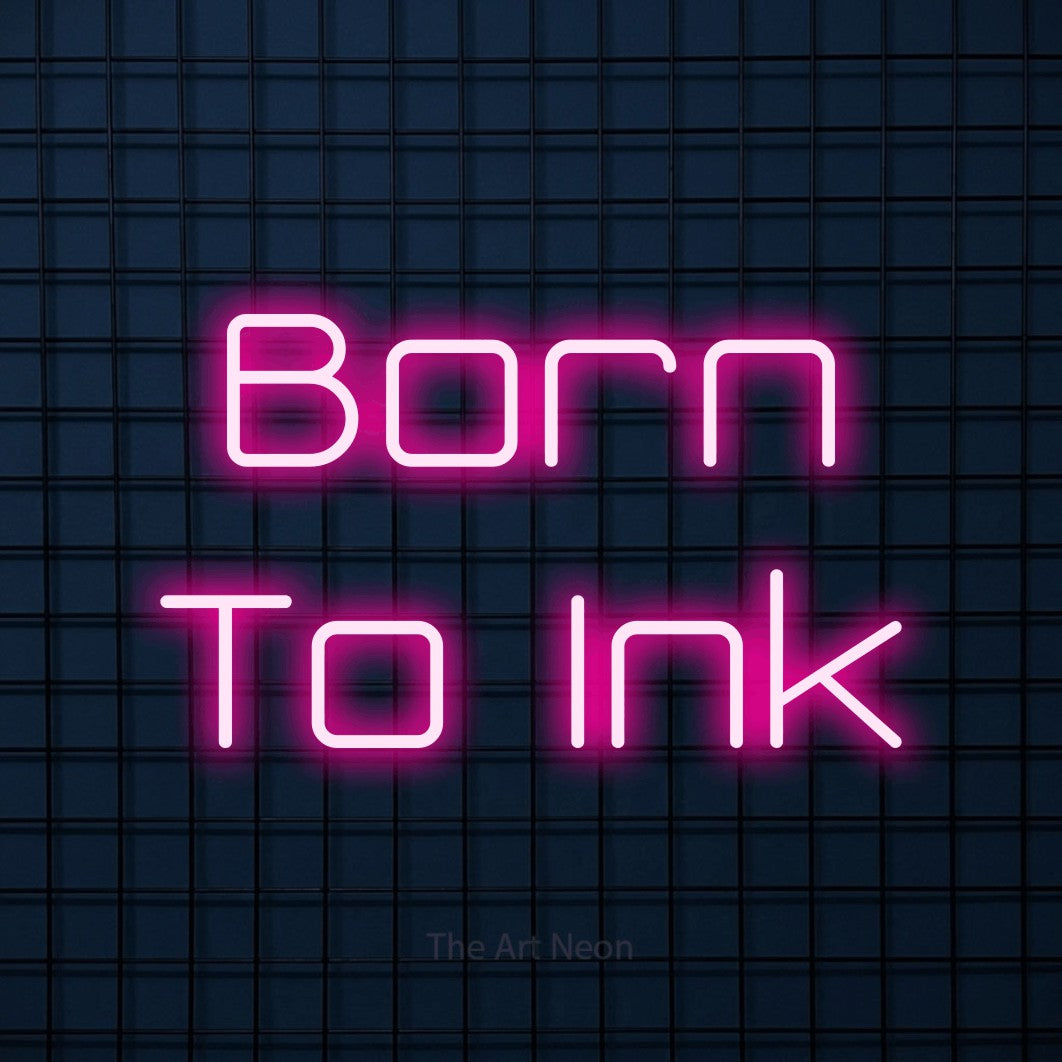 LED neon sign reading “Born To Ink”, arranged in 2 lines.