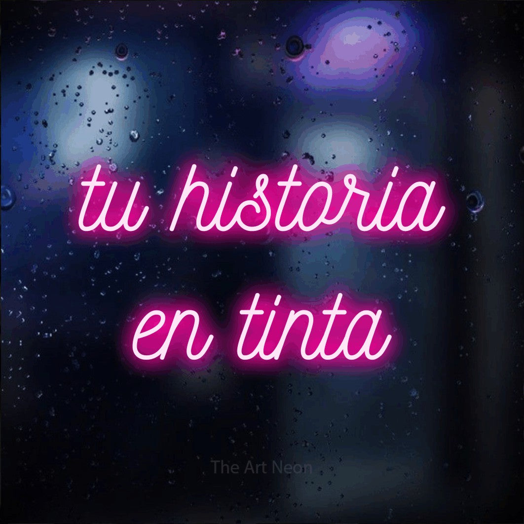 LED neon sign reading “tu historia en tinta”, arranged in 2 lines.