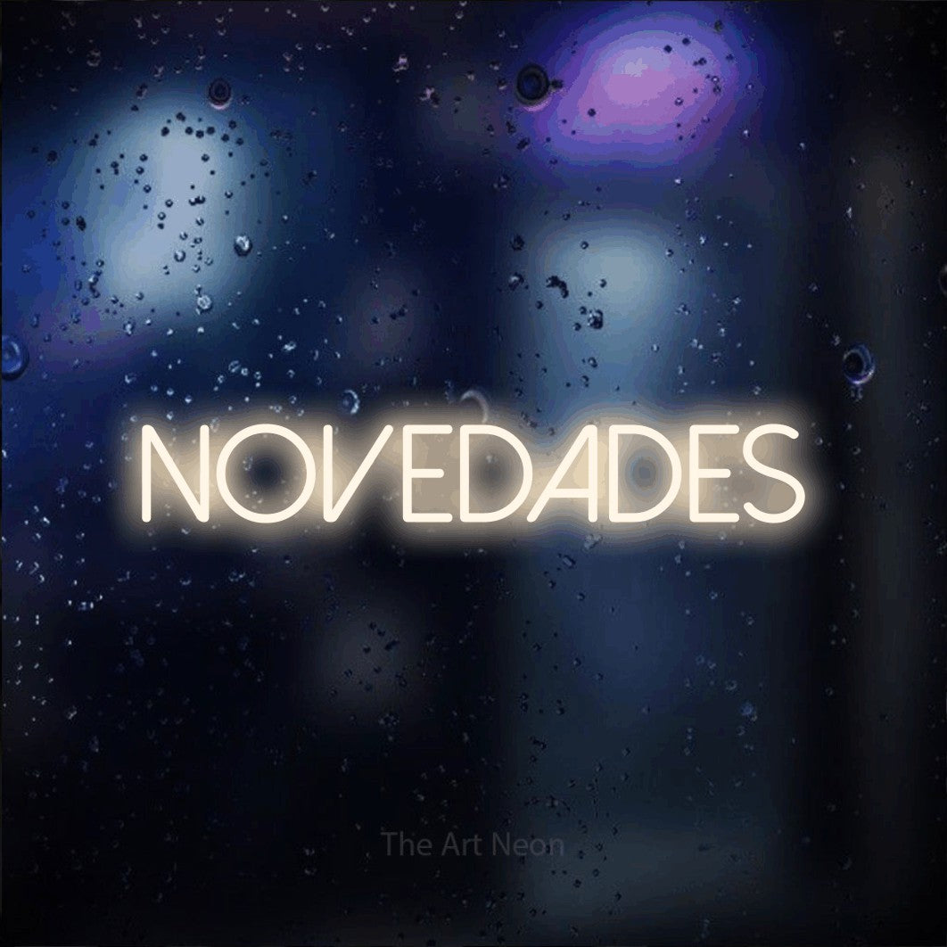 LED neon sign reading “novedades”, arranged in a single line.