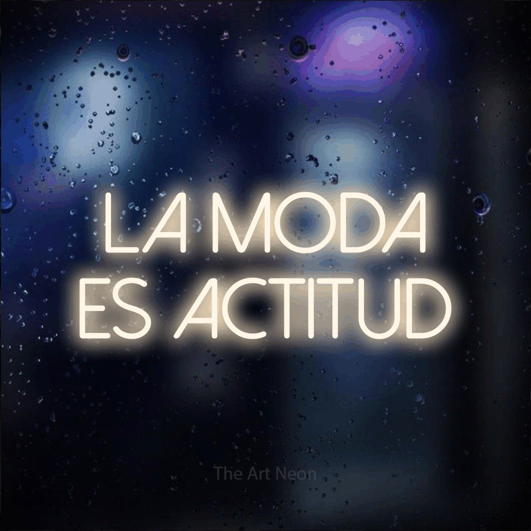LED neon sign reading “La moda es actitud”, arranged in 2 lines.