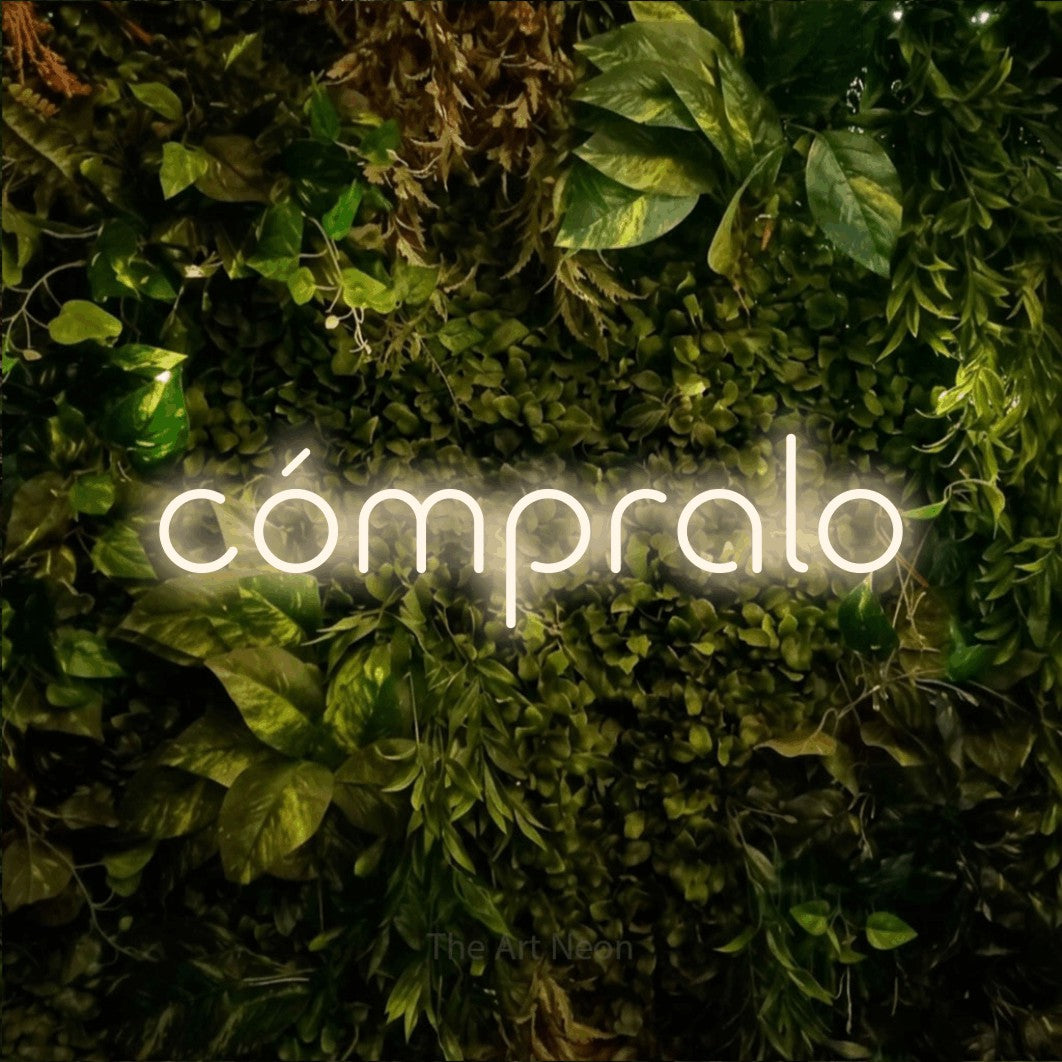 LED neon sign reading “cómpralo”, arranged in a single line.