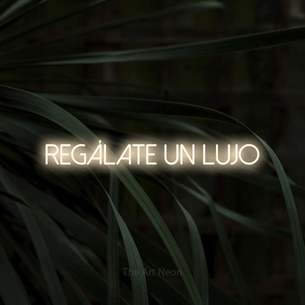 LED neon sign reading “regálate un lujo”, arranged in a single line.