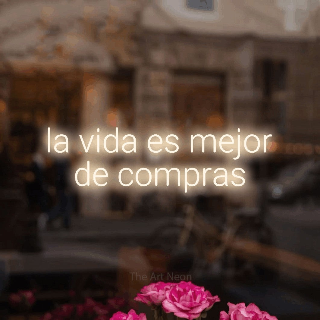 LED neon sign reading “la vida es mejor de compras”, arranged in 2 lines.