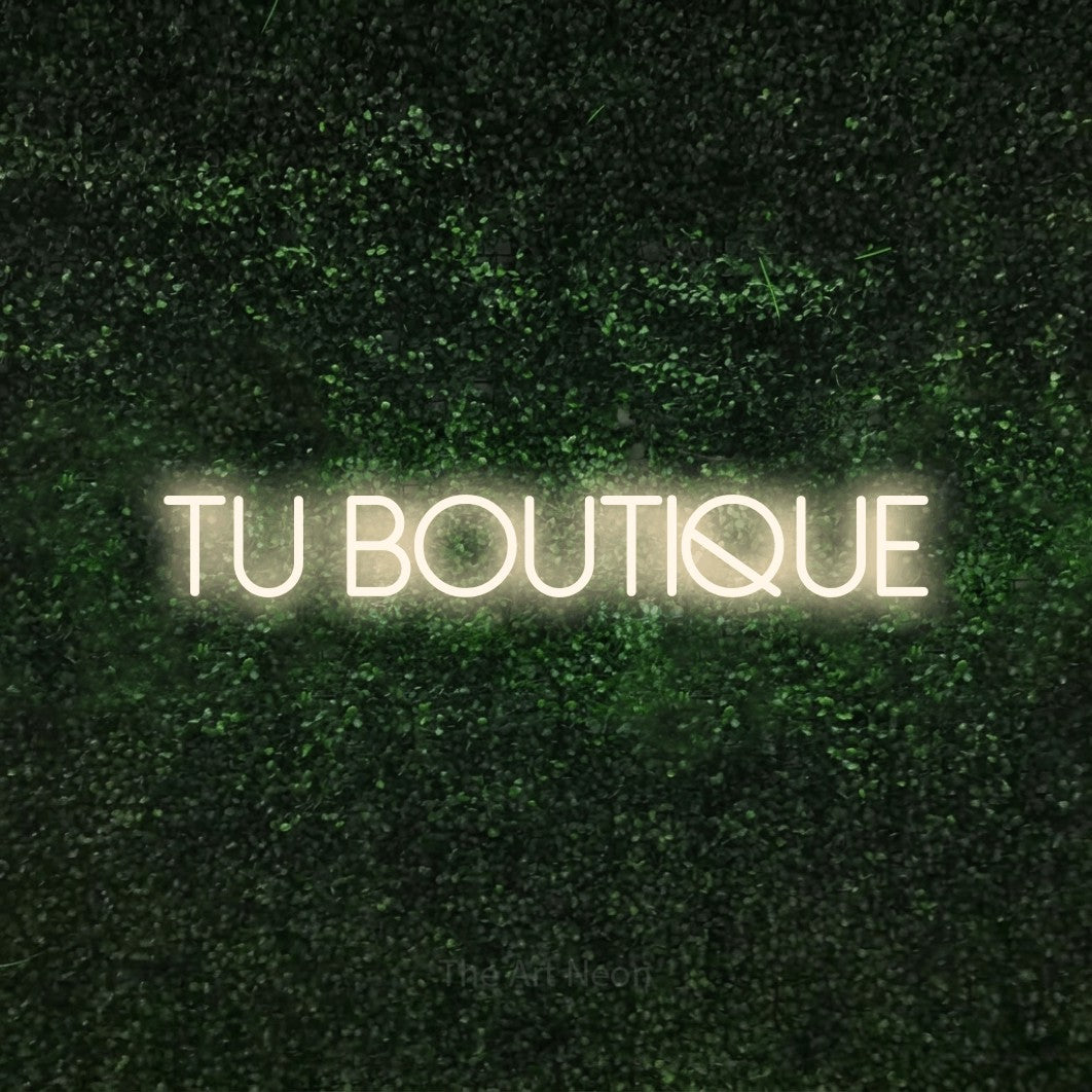 LED neon sign reading “TU BOUTIQUE”, arranged in a single line.
