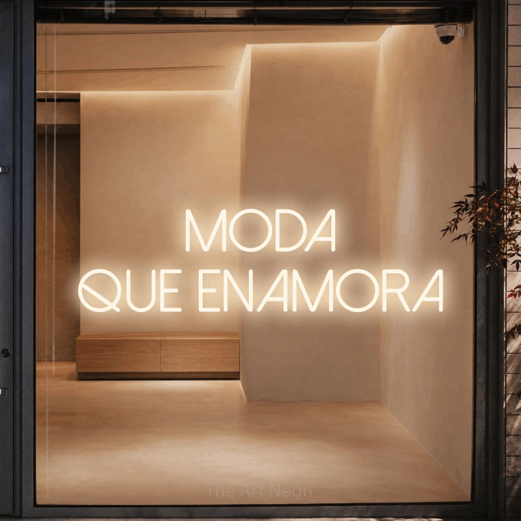 LED neon sign reading “MODA QUE ENAMORA”, arranged in 2 lines.