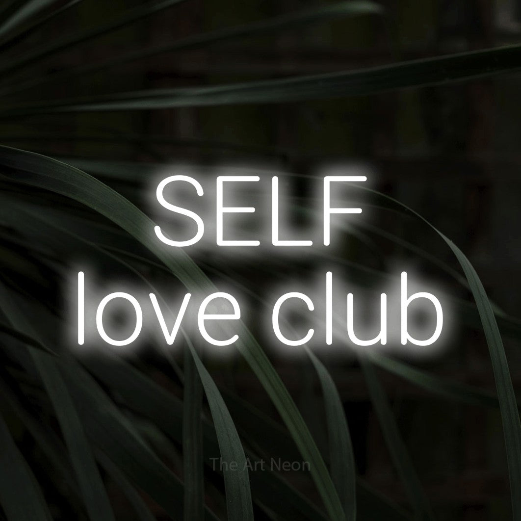 LED neon sign reading “SELF love club”, arranged in 2 lines.