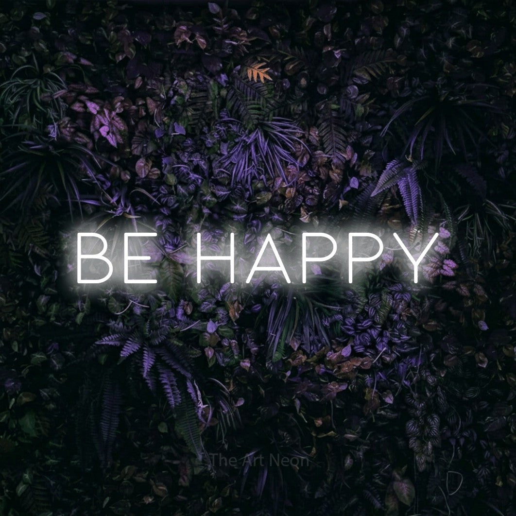 LED neon sign reading “be happy”, arranged in a single line.