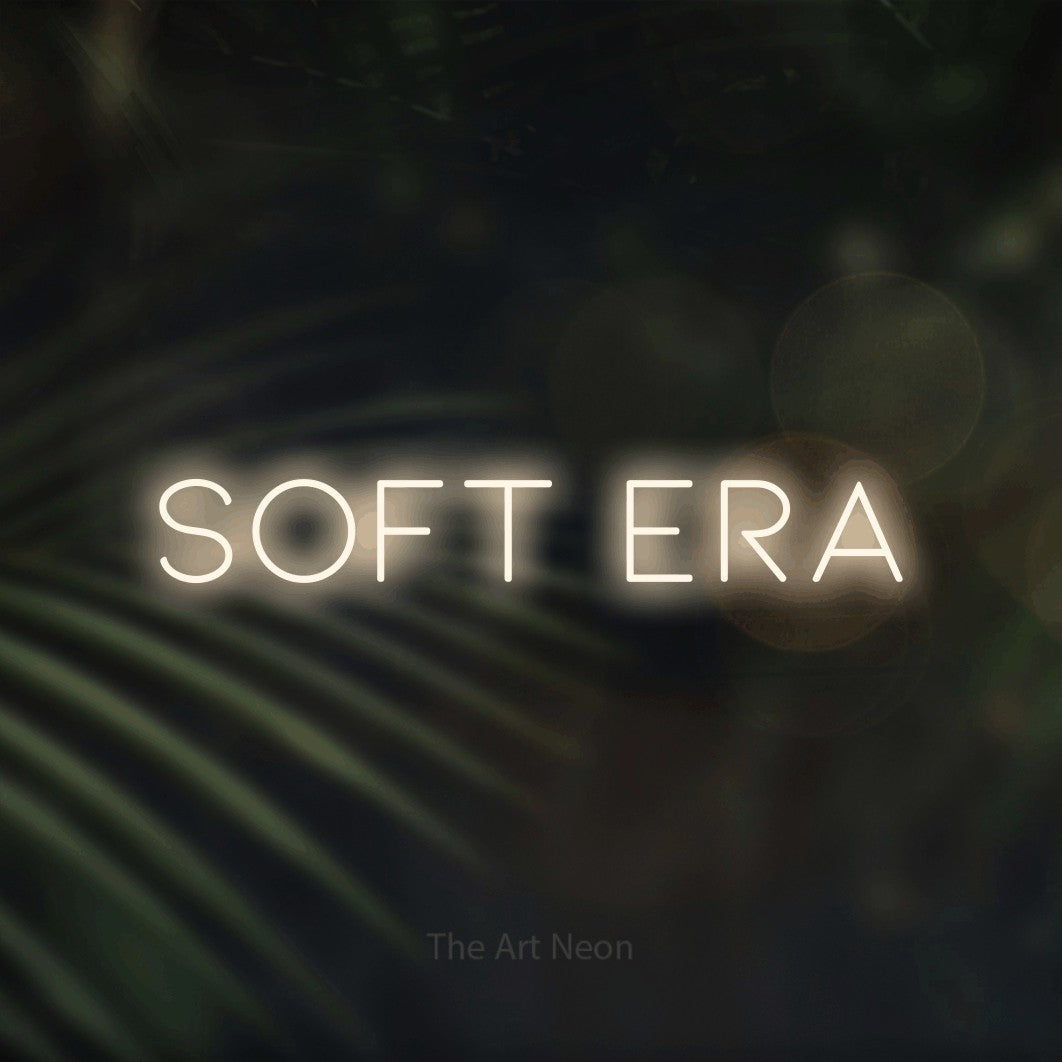 LED neon sign reading “soft era”, arranged in a single line.