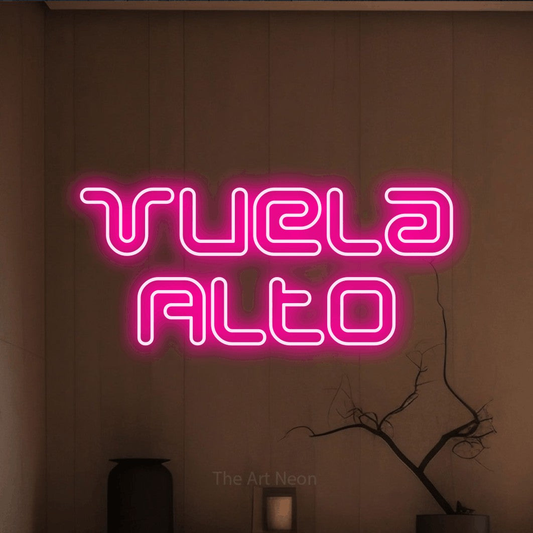LED neon sign reading “Vuela Alto”, arranged in 2 lines.