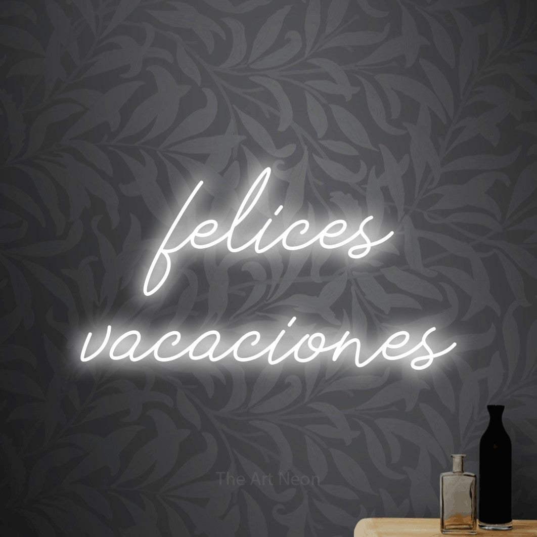 LED neon sign reading “felices vacaciones”, arranged in 2 lines.