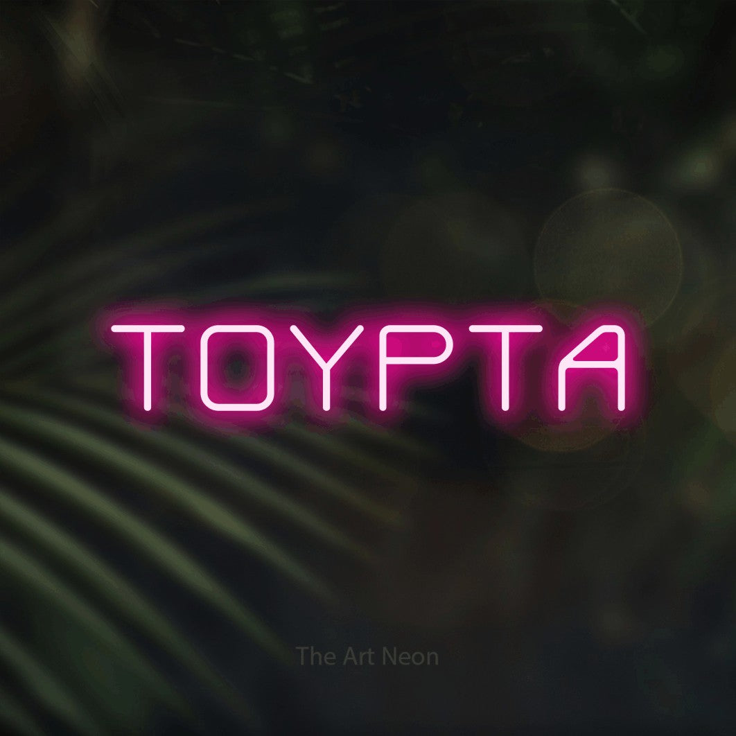 LED neon sign reading “ΤΟΥΡΤΑ”, arranged in a single line.